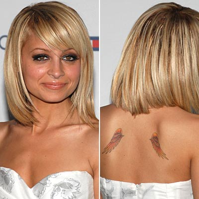 angel wings with letter tattoo